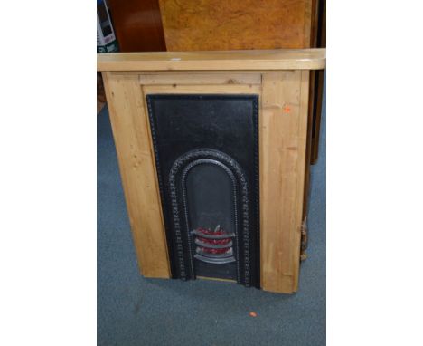 A MODERN PINE FIRE SURROUND with a cast iron insert and simulation lights in grate, width 90cm x height 111cm