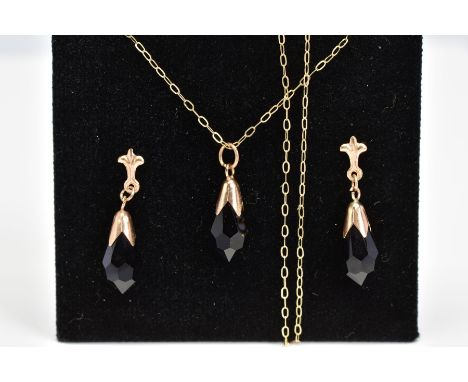 A PENDANT NECKLACE AND MATCHING DROP EARRINGS, the pendant designed as a faceted pear shape black glass drop in cap setting s
