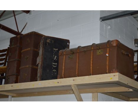 A LEATHER AND WOODEN BOUND SHIPPING TRUNK together with two  travelling trunks and a leather and black ground suitcase (4)