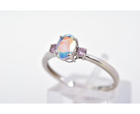 A 9CT WHITE GOLD CUBIC ZIRCONIA RING, designed as a central oval opalescent cubic zirconia flanked by circular pink cubic zir