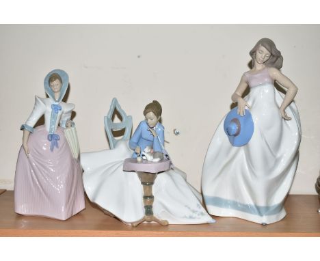 THREE NAO FIGURES, 'Girl Playing with Kitty' No1355, height 22cm, young woman with parasol, No1251, height 27.5cm and a young