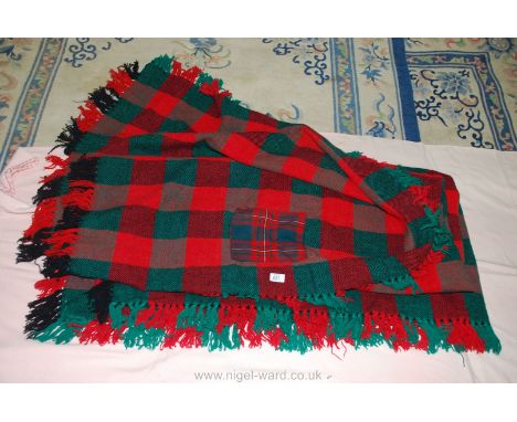 Chequered fringed picnic rug with patch repair.