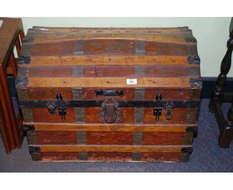 Wooden domed top travel trunk, 28" long x 21" high x 18" deep.