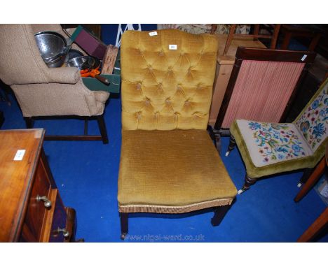 Mustard colour velour button back nursing chair with porcelain casters.