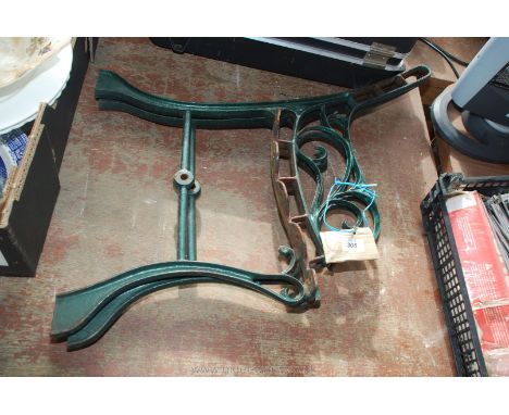 Pair of green wrought iron bench ends.