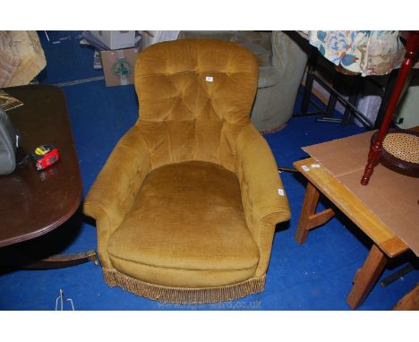 Mustard colour button back armchair.