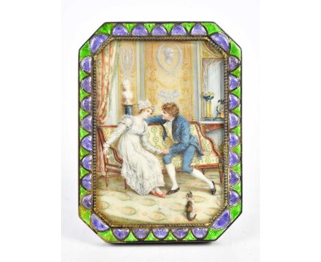 A late 19th century hand painted watercolour and ivory portrait miniature representing a couple in interior scene, in a shape