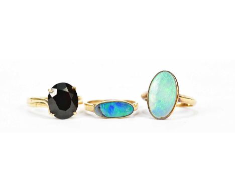 Two opal set yellow metal dress rings, both stamped 18k, and a 14ct yellow gold dress ring, combined approx. 9.95g (3)