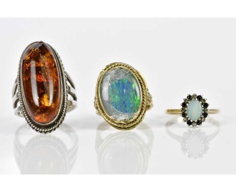 A 9ct yellow gold opal dress ring, size K, approx. 2g, a large yellow metal dress ring with badly damaged opal, size L, appro