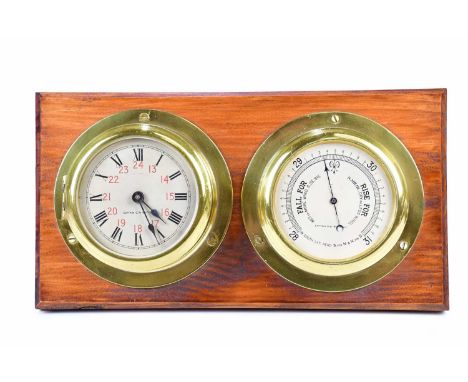 CAPTAIN O M WATTS; a brass cased ship's clock set with Roman and Arabic numerals, with thermometer mounted on a stained woode