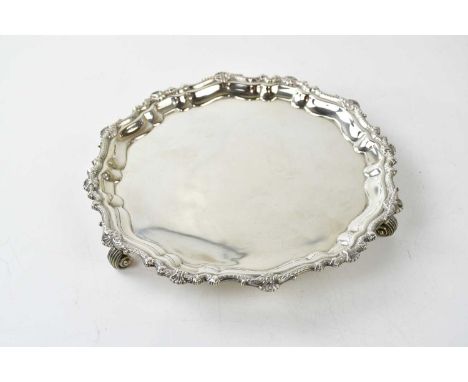 BEAVER LTD; a George V hallmarked silver salver with cast edge on three scrolling feet, Birmingham 1935, approx 12.2ozt/382g.