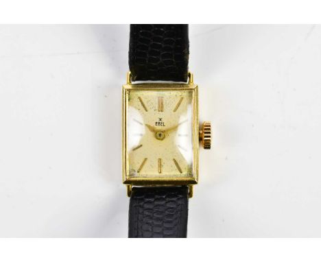 EBEL; a lady's 18ct gold cased wristwatch, the silvered dial set with batons, width 12mm, on a black leather strap.Condition 