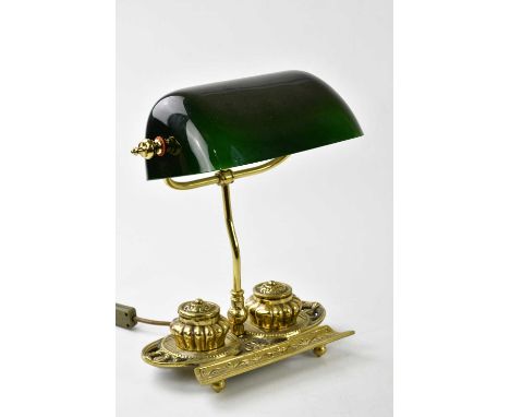 A reproduction gilt metal desk lamp with rotating green glass shade, the base section with detachable inkwells and pen tray, 
