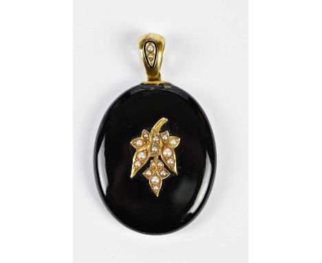 A Victorian black onyx and seed pearl decorated mourning locket with enamel and pearl detail to the bail, length 55mm, (af).C