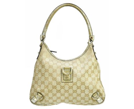 GUCCI; a monogram canvas GG D-ring shoulder bag trimmed with gold leather, with gold tone hardware ring details front and bac