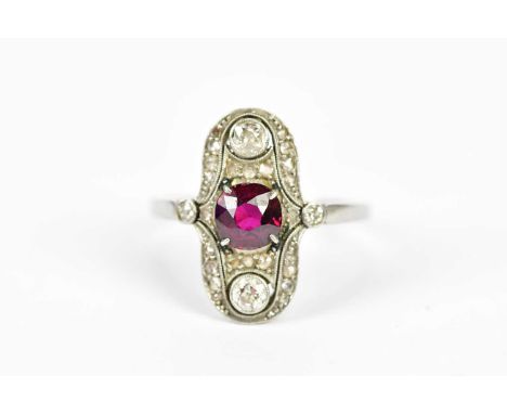 A yellow and white metal Art Deco ruby and diamond plaque ring, the central ruby weighing approx. 0.5cts, within a framework 