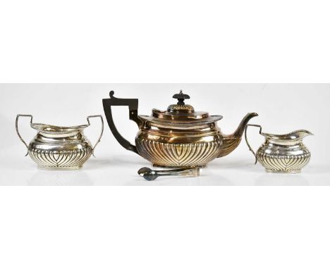 THOMAS HAYES; a Victorian hallmarked silver three piece tea service, with gadrooned decoration, Birmingham 1898, and associat