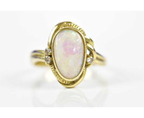 A 14ct yellow gold opal and diamond ring, size O, approx 3.48g.Condition Report: The opal has surface scratches and a tiny ed