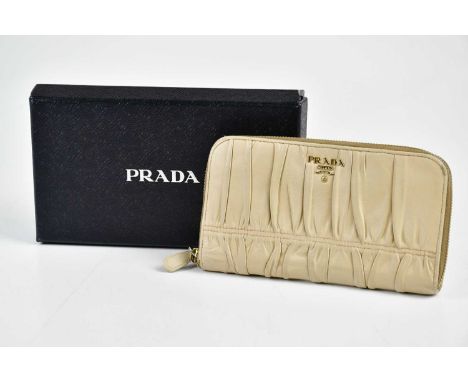 PRADA; an ecru cream nappa gauffre purse wallet with gold tone zip top, authenticity card and original box, 18 x 10cm.Conditi