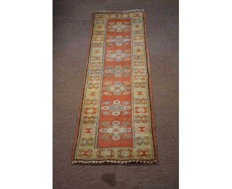 A hand woven wool runner, worked with seven gulls against a red ground, 295 x 88cm.