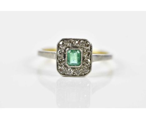 An 18ct yellow gold emerald and diamond cluster ring, the step cut emerald weighing approx. 0.25cts, surrounded by twelve sin