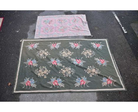 A tapestry carpet, worked with floral motifs against a green ground, 250 x 156cm, with a smaller pink ground tapestry rug. 17