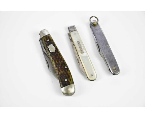 A mother of pearl silver bladed fruit knife, the plaque engraved ‘K. Grace’, and two further pocket knives (3)