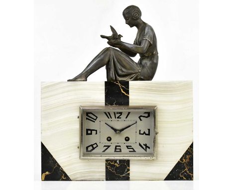 An Art Deco alabaster slate and marble figural mantel clock modelled with a spelter seated figure holding a bird to the top a