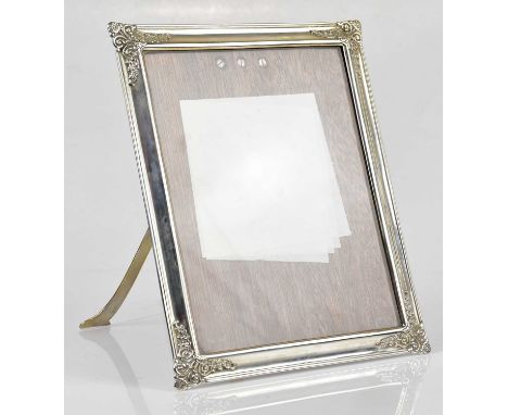 TIFFANY &amp; CO; a sterling silver easel back photograph frame, with cast scrolling detail to each of the four corners, stam