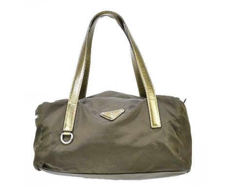 PRADA; a brown nylon and antique gold leather bowling bag with side zip pocket, top handles and original dust bag, 29 x 16 x 