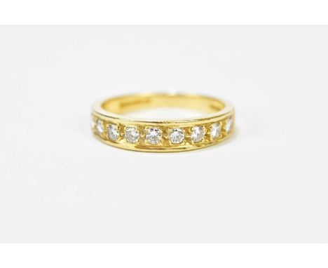 An 18ct yellow gold and nine stone half eternity ring, size M, approx. 3.46g.
