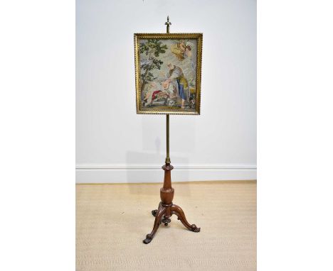 A Victorian pole screen with framed tapestry panel of a religious scene, on tripod base, height 170cm.