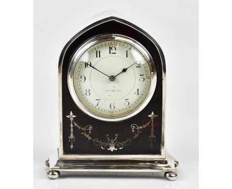 ADIE BROTHERS LTD; a George V hallmarked silver and faux tortoiseshell mantel clock of arched form, the dial set with Arabic 