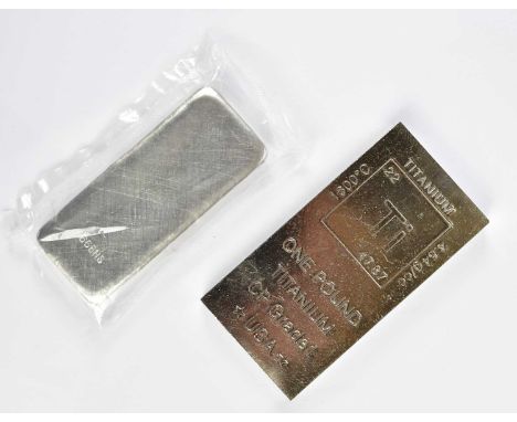 A one pound bar of titanium and another white metal bar (2).