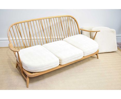 ERCOL; a light elm three seater spindle back sofa, length 177cm.