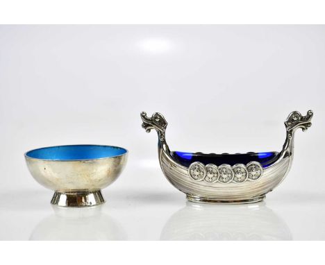 Two Norwegian silver salts, one modelled as a Viking boat, length 8cm, the other with a blue enamel interior, diameter 5cm.