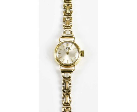 BUCHERER; a lady's vintage gold wristwatch with 18ct gold head set with baton markers and with 9ct yellow gold bracelet, comb