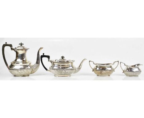 A silver plated four piece tea service with gadrooned decoration to the lower body, with presentation inscription to the coff