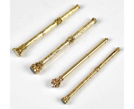 Three Victorian yellow metal propelling pencils, including an example with chased decoration and hexagonal hardstone terminal