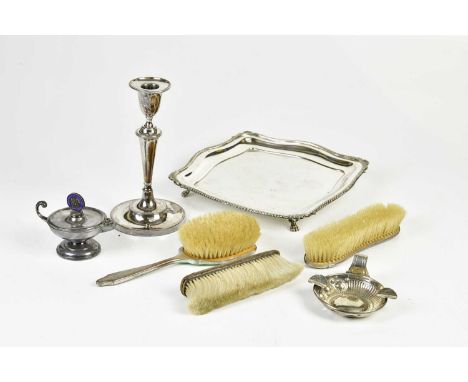 A hallmarked silver mounted dressing table brush, marks worn, with a wine taster / ash tray, a plated candlestick, a green en