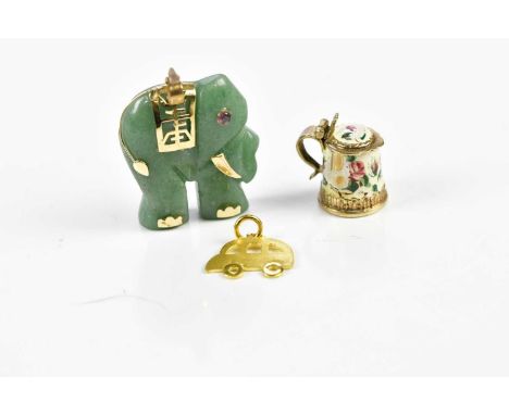 A Chinese inspired carved green stone pendant modelled as an elephant with yellow metal mounts, a 9ct yellow gold and enamel 