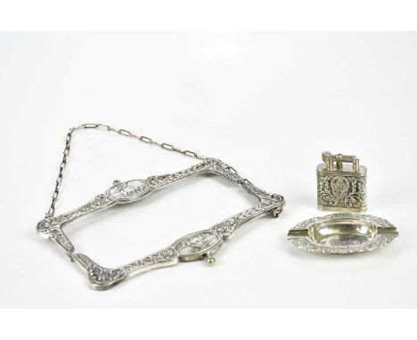 HOLLAND &amp; AFRIKA (SIC); a white metal ashtray and cigarette lighter, also a similarly decorated purse frame (3)