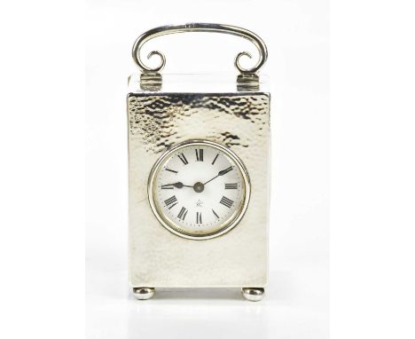 CHARLES HENRY DUMENIL; a George V hallmarked silver cased carriage clock, the case with swing handle and planished decoration