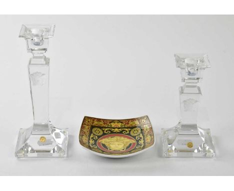 VERSACE; an unused Rosenthal ceramic square dish depicting Medusa, 12 x 12cm, and two crystal candlesticks, 20cm and 15cm, wi