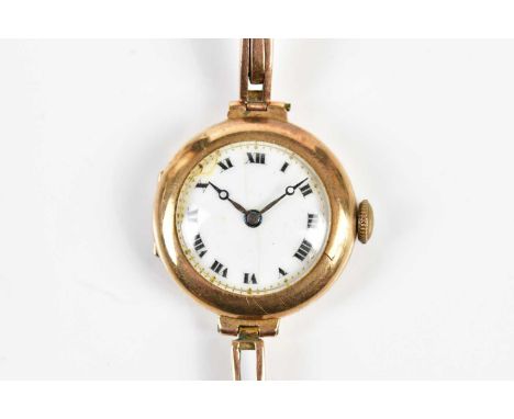 A 9ct yellow gold cased lady's wristwatch, with white enamel dial set with Roman numerals, 17.2g. 