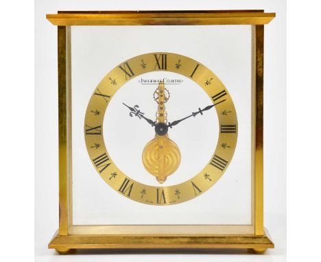 JAEGER-LECOULTRE; a gilt metal cased skeleton clock, the chapter ring set with Roman numerals, height 17cm, with applied pres