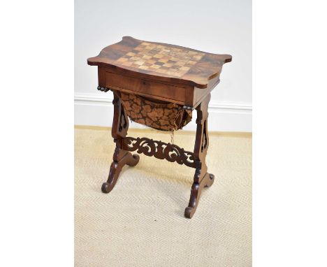 A Victorian mahogany sewing table with chessboard top above drawer and basket, width 58cm, depth 39cm, height 73cm.