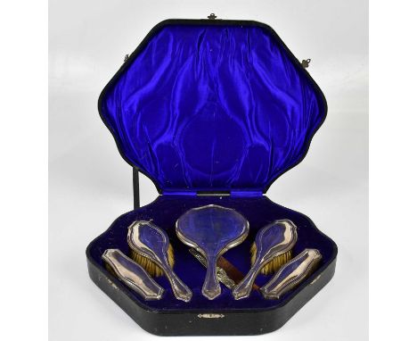 CHARLES BOYTON &amp; SON LTD; a George V hallmarked silver five piece dressing table set comprising mirror, two hairbrushes a