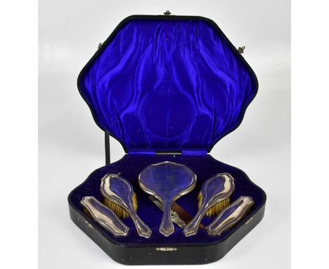 CHARLES BOYTON &amp; SON LTD; a George V hallmarked silver five piece dressing table set comprising mirror, two hairbrushes a