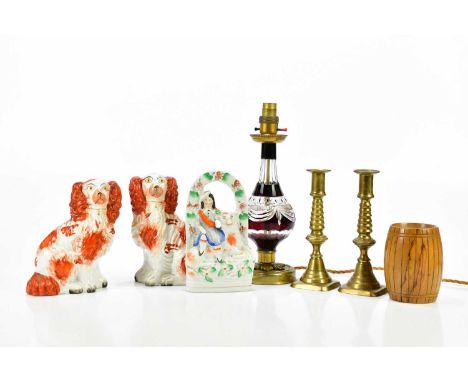 A pair of Staffordshire figures, together with a further Staffordshire flatback, a pair of brass candlesticks, a wooden money
